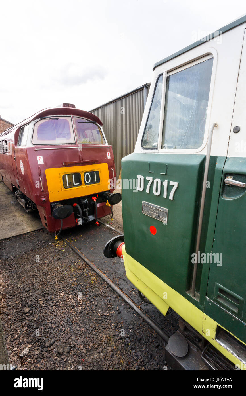 Two 1960s design BR diesel hydraulic locomotives D1010 & D7017 in a siding at Williton station, West Somerset Railway, England, UK Stock Photo