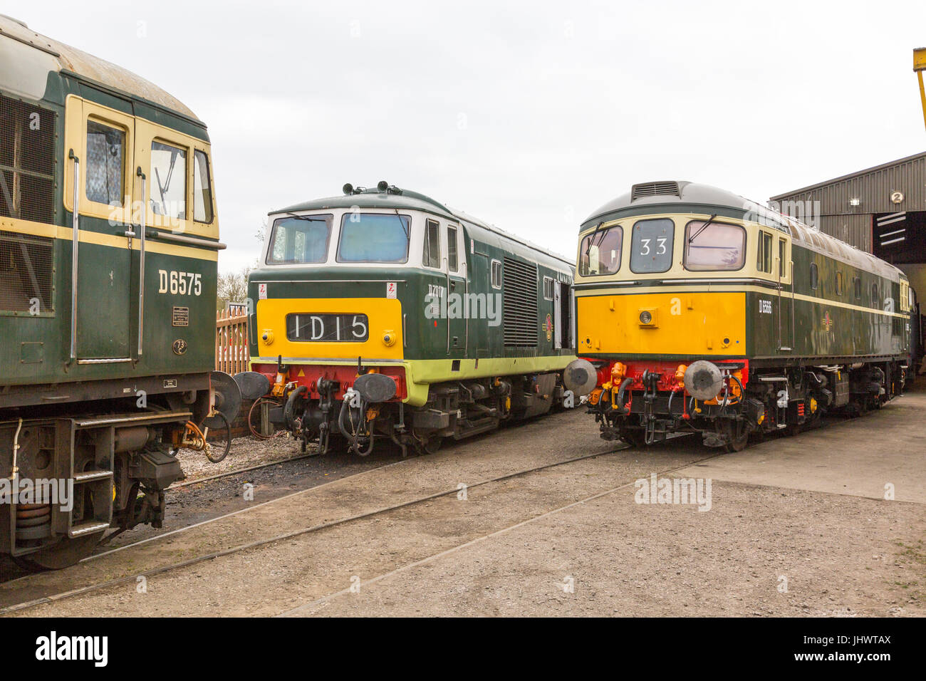 Three 1960s design BR diesel electric & diesel hydraulic locomotives D6575, D6566 & D7017 at Williton diesel depot, West Somerset Railway, England, UK Stock Photo
