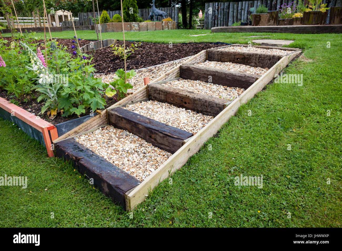 Steps made using timber and gravel in a domestic garden UK Stock Photo
