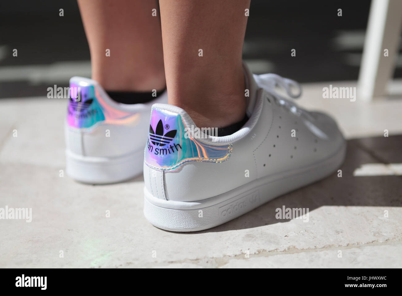 Stan Smith Adidas Trainers on Feet on Ground Stock Photo - Alamy