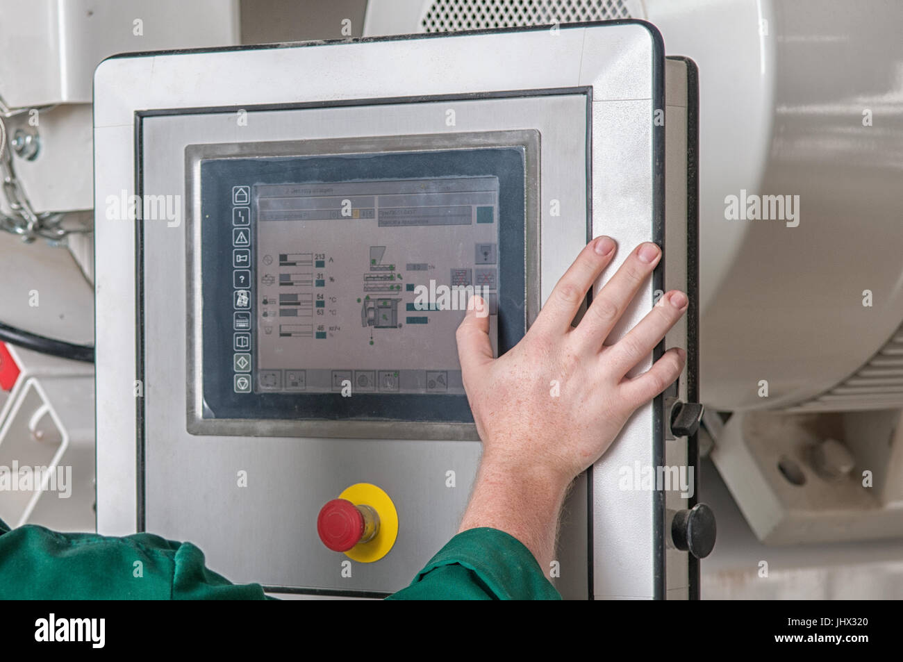 pressing important technology button at control panel in plant Stock Photo