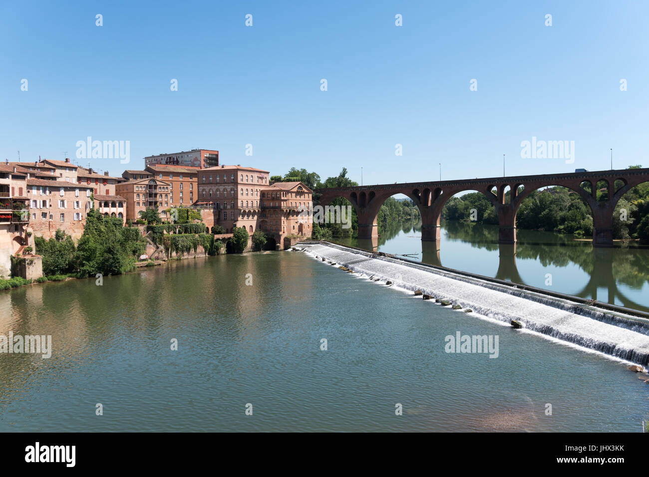 The weir across the river Tarn in Albi with the Mercure Hotel at the end of the bridge, France Stock Photo