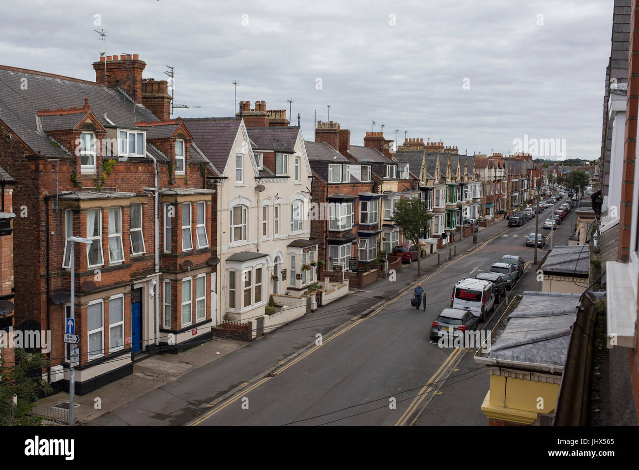 Aerial view of a person carrying items across Marshall Street, on 14th