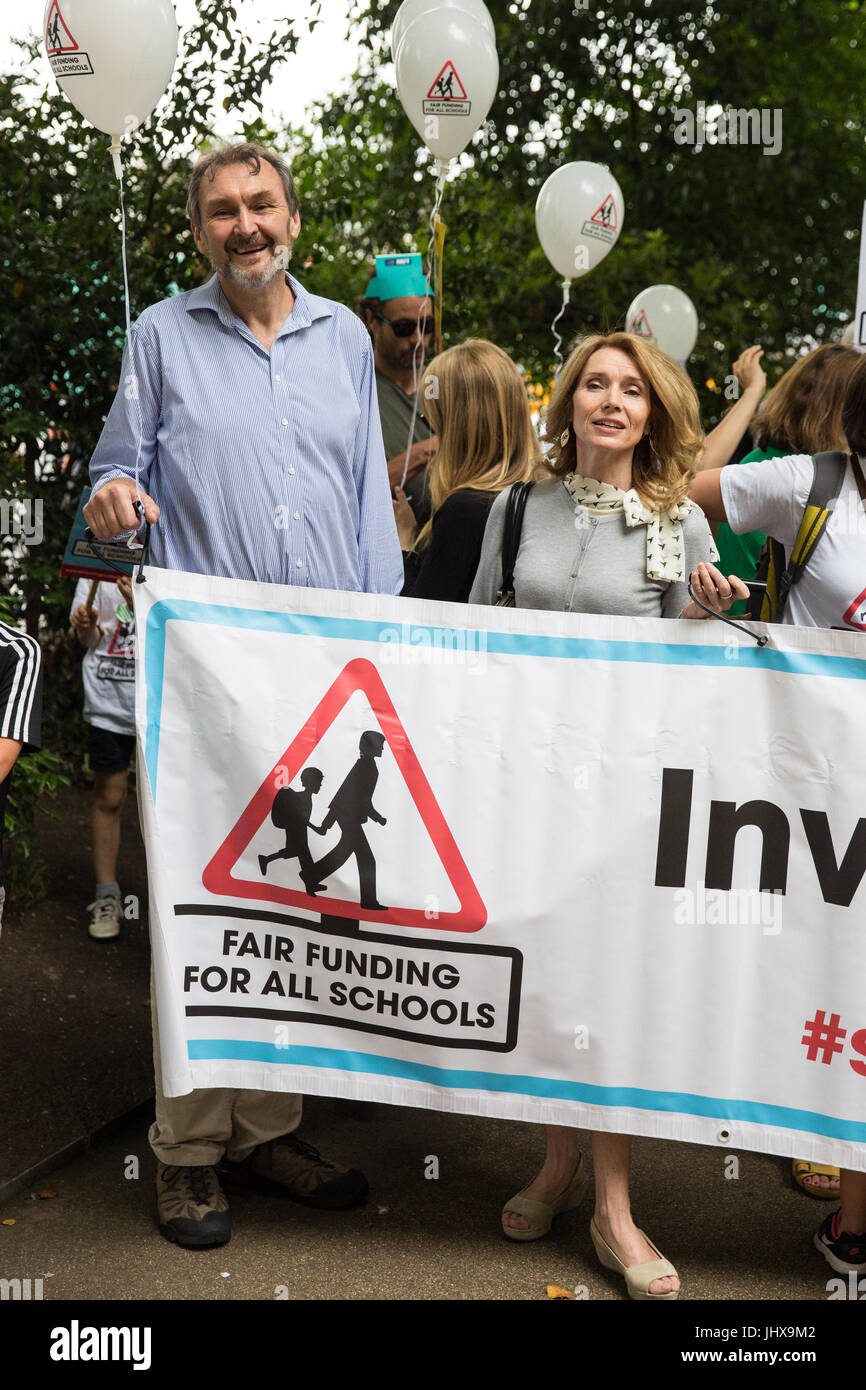London, UK. 16th July, 2017. Kevin Courtney, General Secretary of the National Union of Teachers (NUT) and Mary Sandell, a head teacher who has resigned in protest against education funding cuts after 29 years' service, prepare to march to Parliament Square with other campaigners and their families as part of a Carnival Against The Cuts protest organised by Fair Funding For All Schools. Credit: Mark Kerrison/Alamy Live News Stock Photo