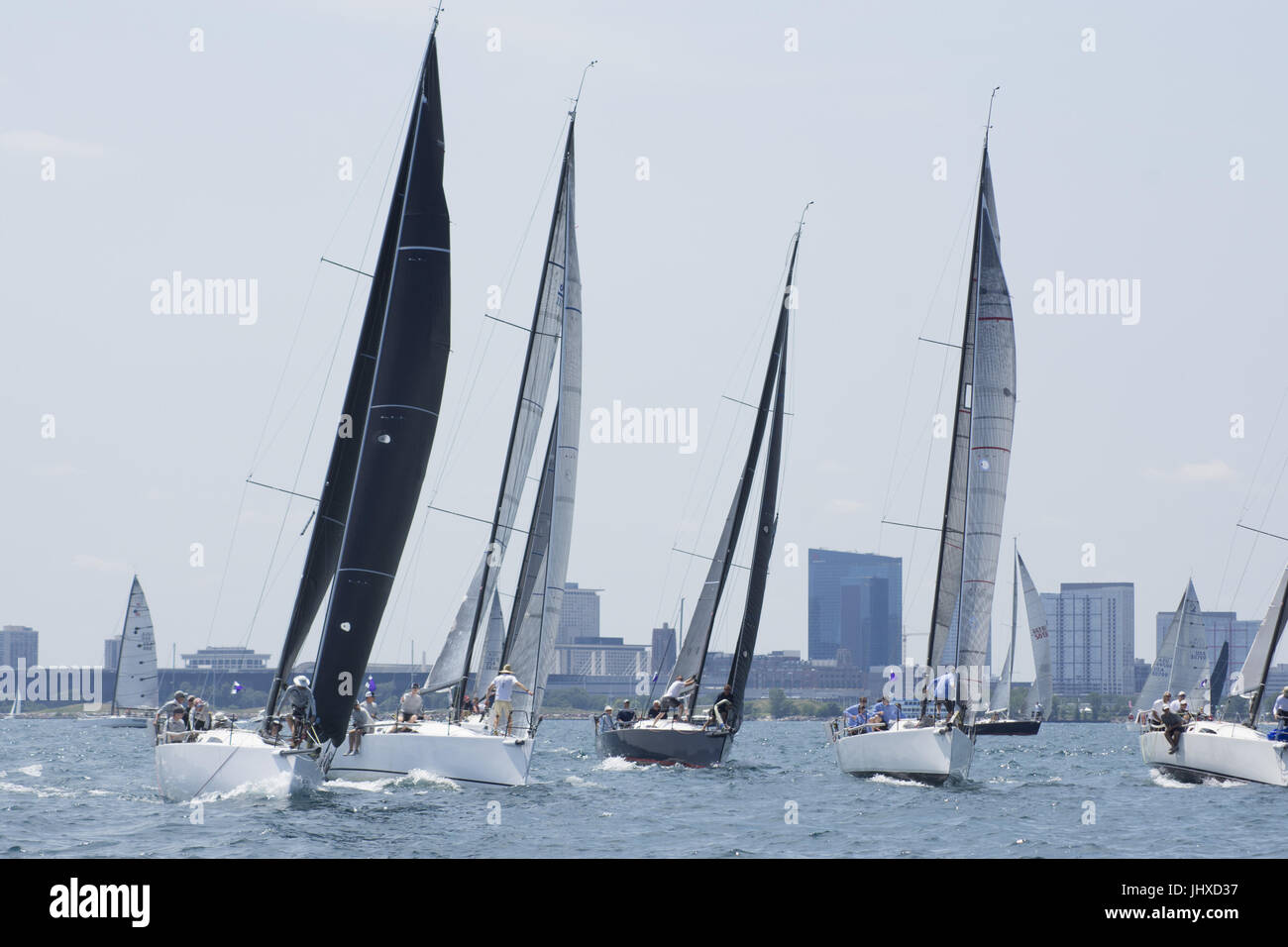 Chicago, IL, USA. 15th July, 2017. The boats are off in the Chicago Race to Mackinac. The ''cruising'' fleet of slower boats started their across-the-lake journey on Friday afternoon, July 14th. On Saturday, 19 fleets of boats began in waves every ten minutes. The largest and fastest boat were in the last two sections - turbo and multihull. The record-holder for time for a monohull occured in 2002 by Roy Disney's Pyewacket at 23 hours 30 minutes. High winds and waves have caused 70 boats to drop out of the race by Sunday afternoon. Two boats capsized. 5 crew members were rescued by another Stock Photo