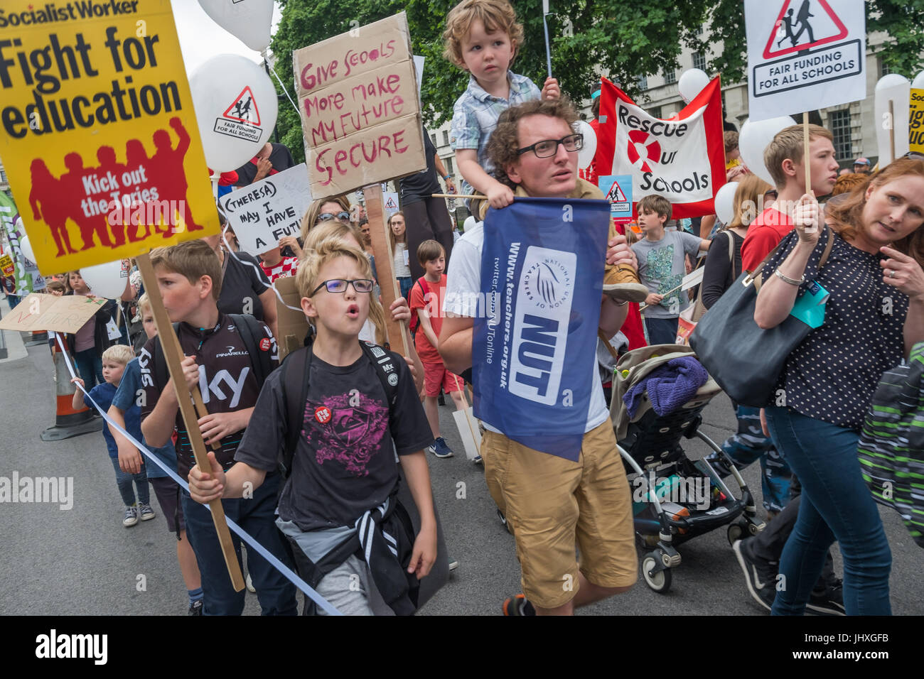 London, UK. 16th July 2017. Many of the hundreds of parents, children, teachers and others marching from Embankment to Parliament Square in a protest against unfair cuts in school funding shouted loudly as they passed Downing St. The 'Carnival Against Cuts' was organised by parents in the 'Fair Funding for All Schools' campaign and supported by the NUT.  arly in the inner cities Credit: Peter Marshall/Alamy Live News Stock Photo