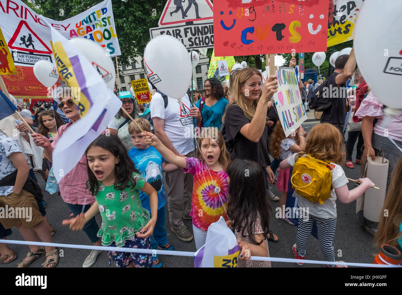 London, UK. 16th July 2017. Many of the hundreds of parents, children, teachers and others marching from Embankment to Parliament Square in a protest against unfair cuts in school funding shout loudly as they pass Downing St. The 'Carnival Against Cuts' was organised by parents in the 'Fair Funding for All Schools' campaign and supported by the NUT.  arly in the inner cities. Ca Credit: Peter Marshall/Alamy Live News Stock Photo