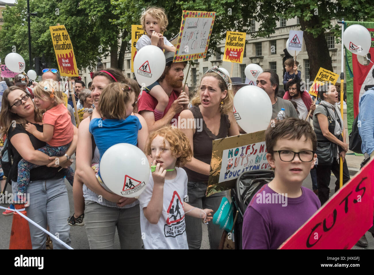 London, UK. 16th July 2017. Many of the hundreds of parents, children, teachers and others marching from Embankment to Parliament Square in a protest against unfair cuts in school funding shout loudly as they pass Downing St. The 'Carnival Against Cuts' was organised by parents in the 'Fair Funding for All Schools' campaign and supported by the NUT.  arly in the inner cities. Ca Credit: Peter Marshall/Alamy Live News Stock Photo