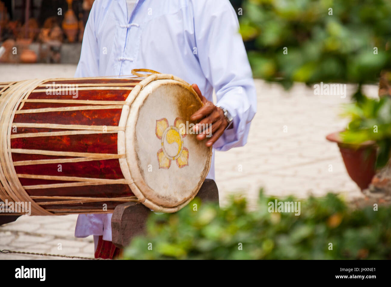 Vietnamese drum. The musician holds the drum and plays it Stock Photo