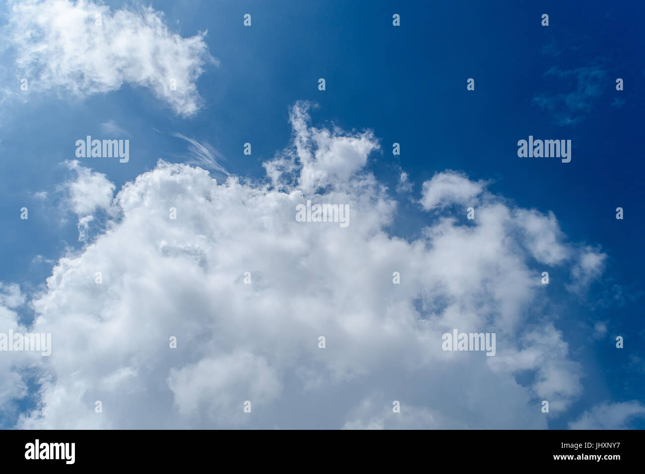 Blue sky with fluffy white clouds Stock Photo - Alamy