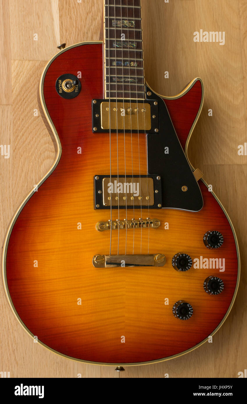 Cherry Westfield Les Paul electric guitar, light wood background with tone  and volume controls and pickup selector switch Stock Photo - Alamy
