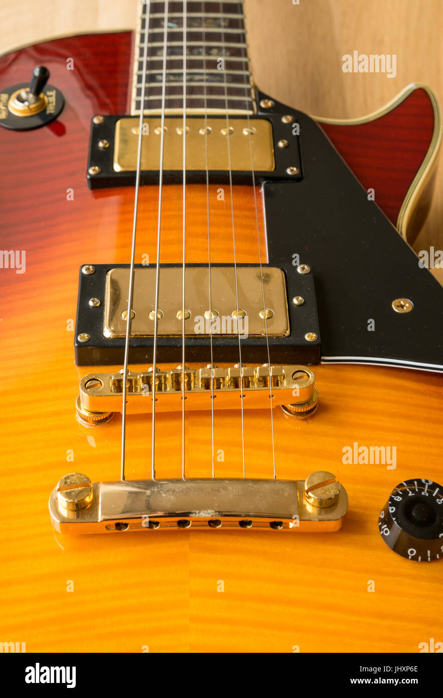 Close up of cherry Westfield Les Paul electric guitar, light wood  background with tone and volume controls and pickup selector switch Stock  Photo - Alamy