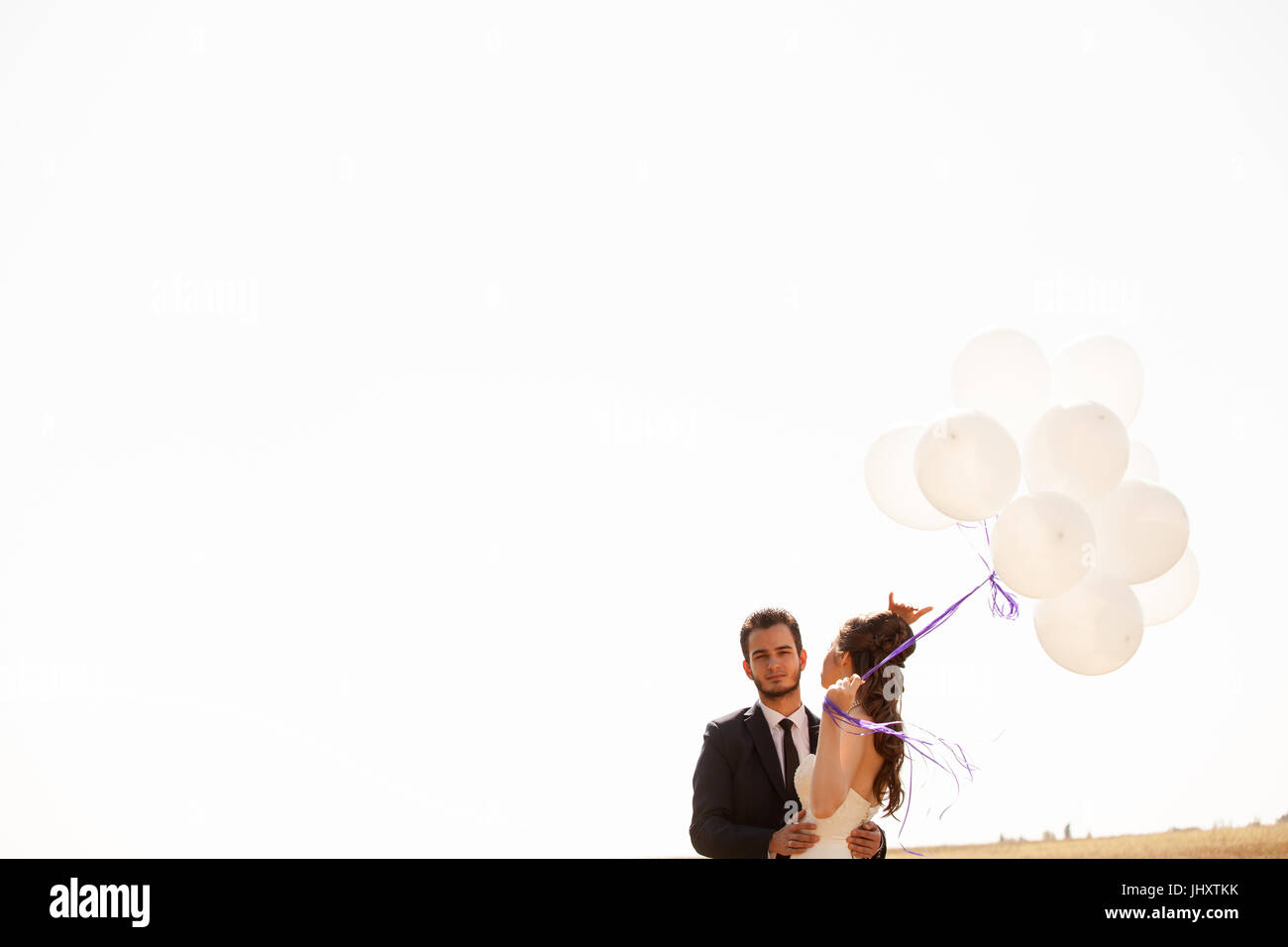 Married happy couple holding ballons in hand Stock Photo - Alamy