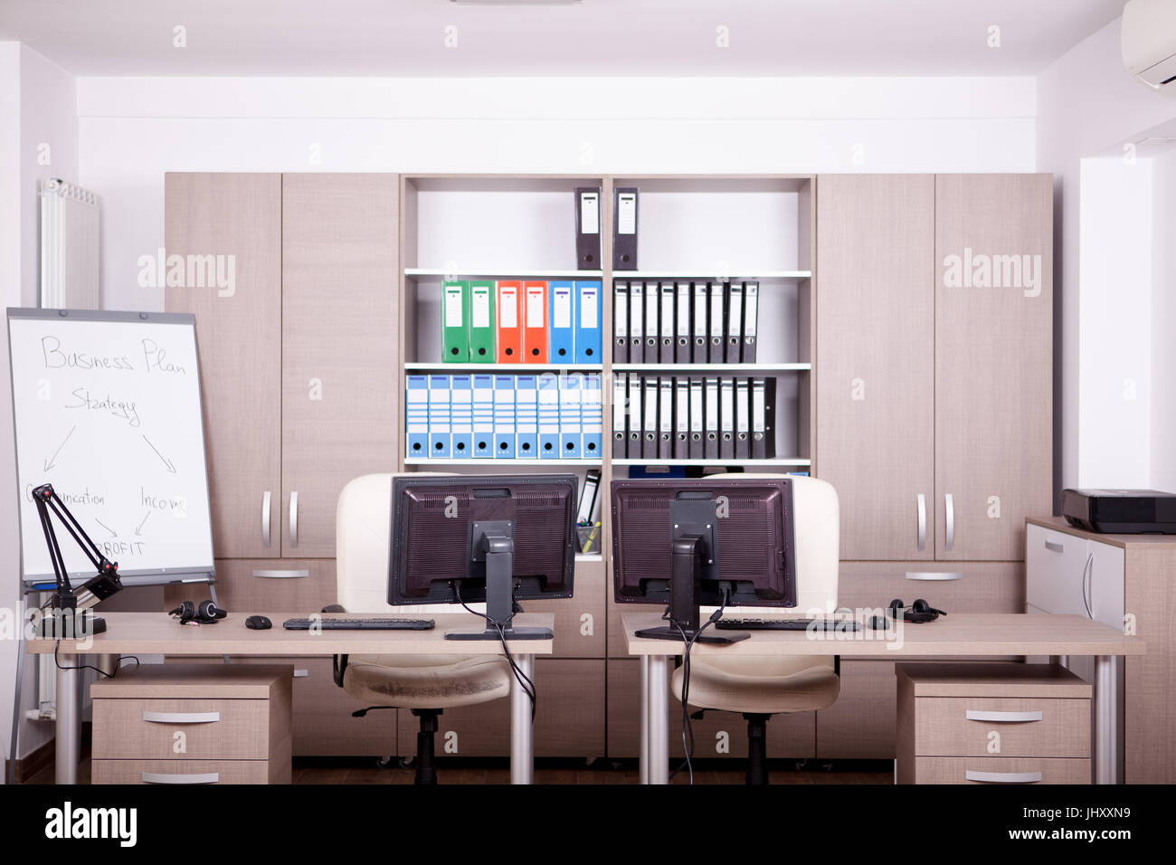 Empty office room with computers and desks Stock Photo - Alamy