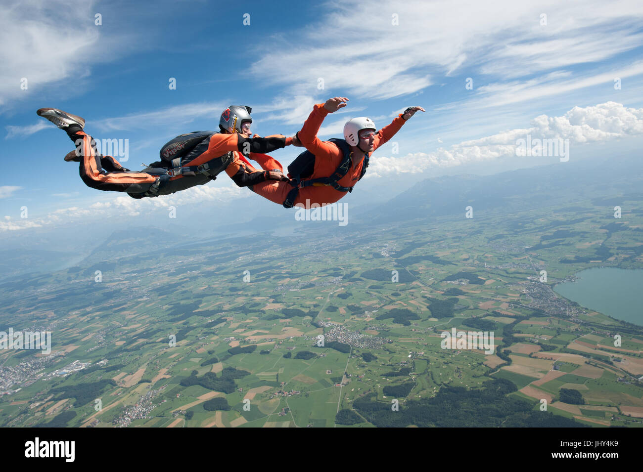 An skydiving instructor is taking a student on a training jump during an AFF course at Beromünster, Switzerland Stock Photo