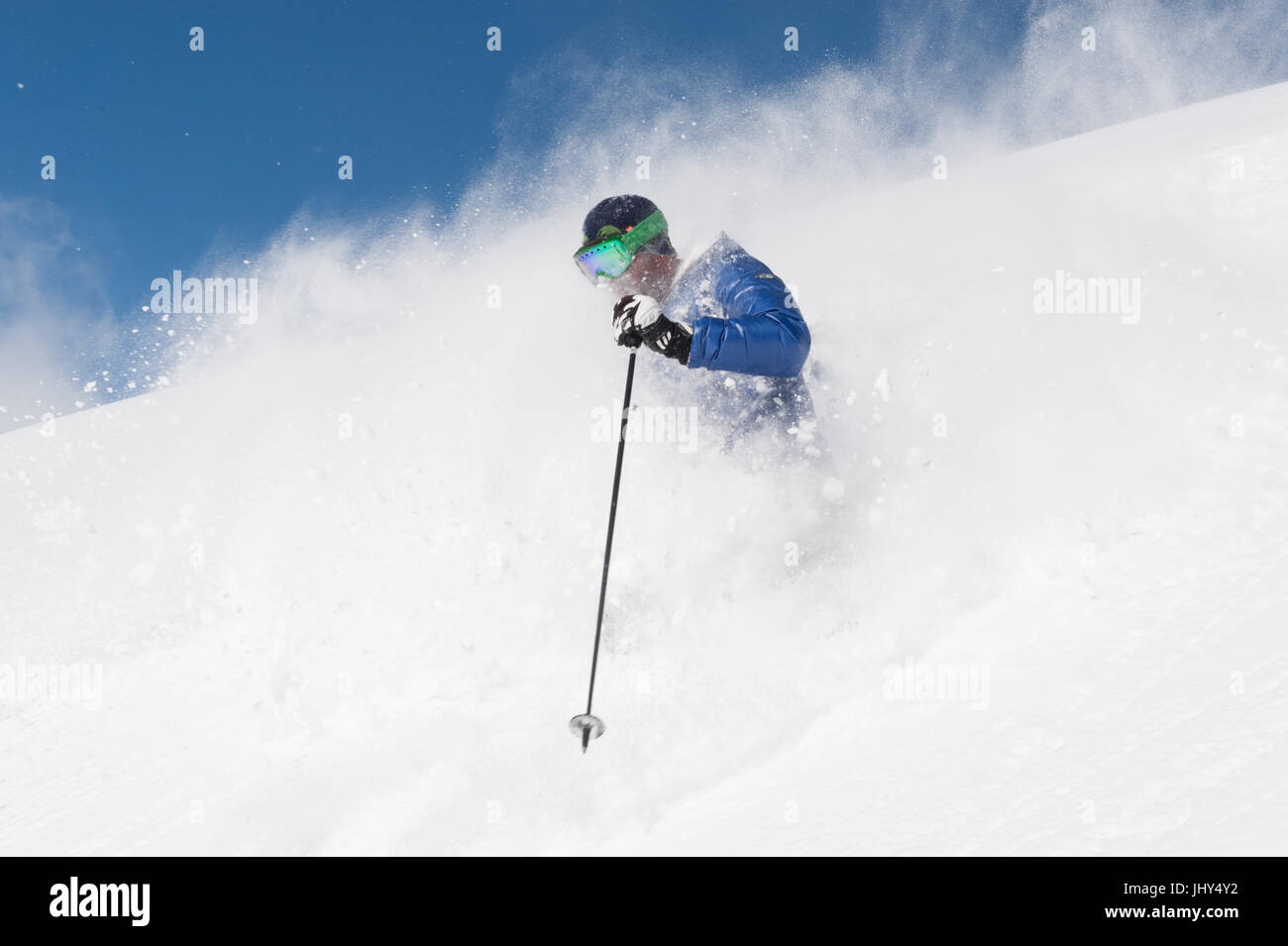 Skier going through fresh powder in the ski region of Disenits,Switzerland Stock Photo
