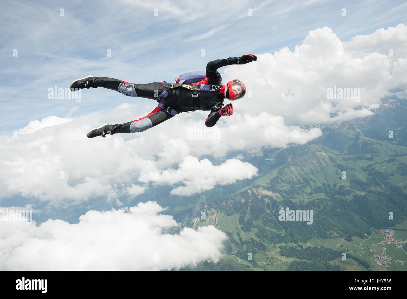 Student skydiver doing a practice jump above Gruyere in Switzerland Stock Photo