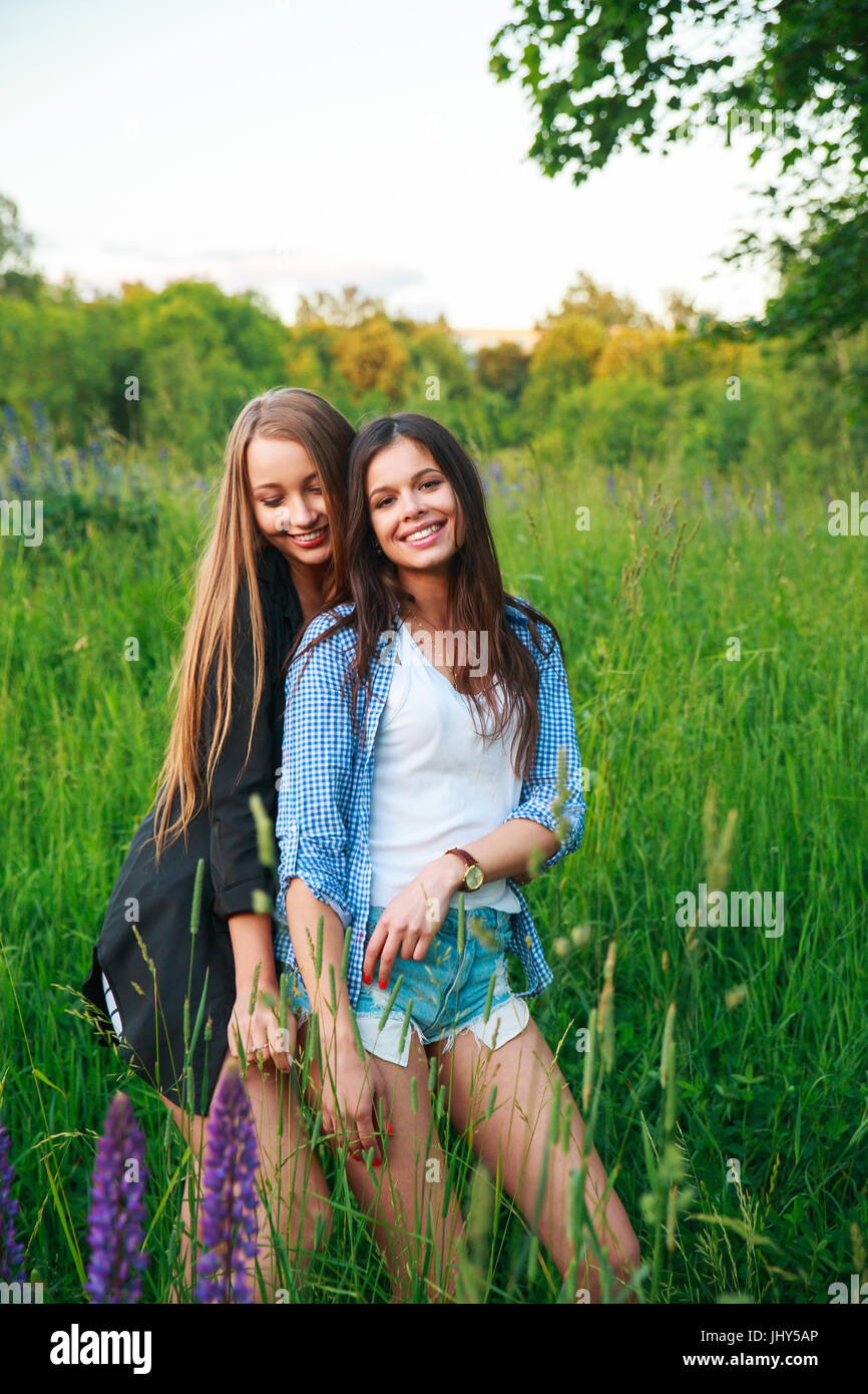 Girlfriends Friendship Happiness Community Concept. Two smiling friends hugging outdoors. Stock Photo