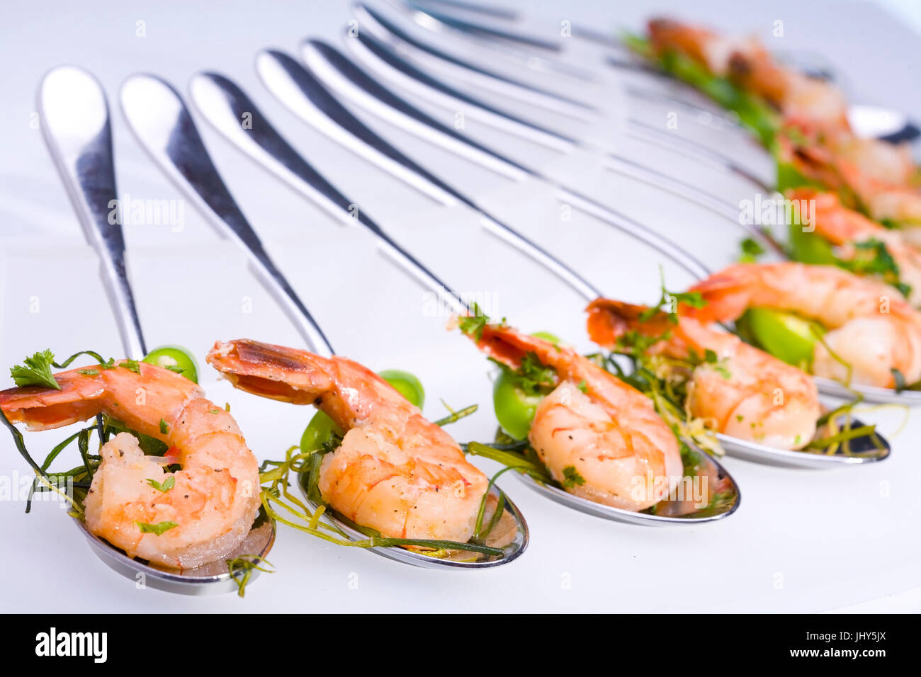 Shrimps on spoon arranged, Garnelen auf Loeffel angerichtet Stock Photo