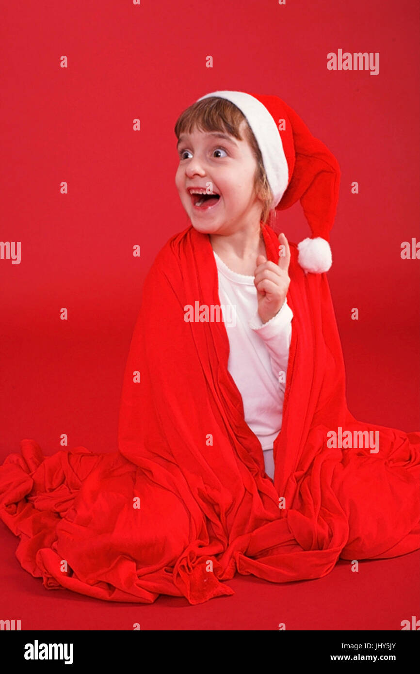 Girls in the Santa Claus costume, Maedchen im Weihnachtsmannkostuem Stock Photo