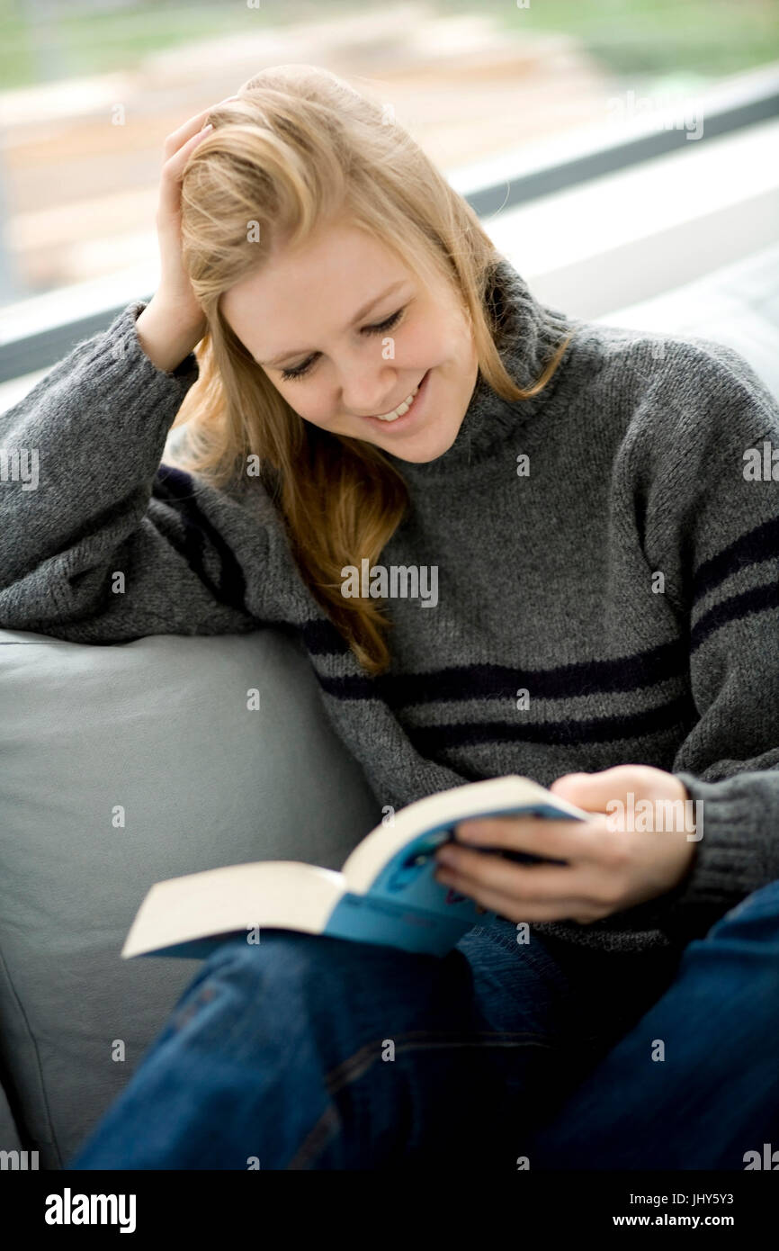 Young woman reads a book, Junge Frau liest ein Buch Stock Photo