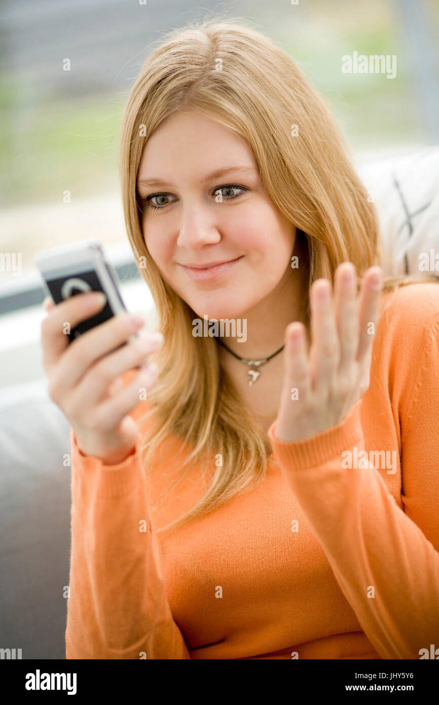 Young woman reads SMS, Junge Frau liest SMS Stock Photo