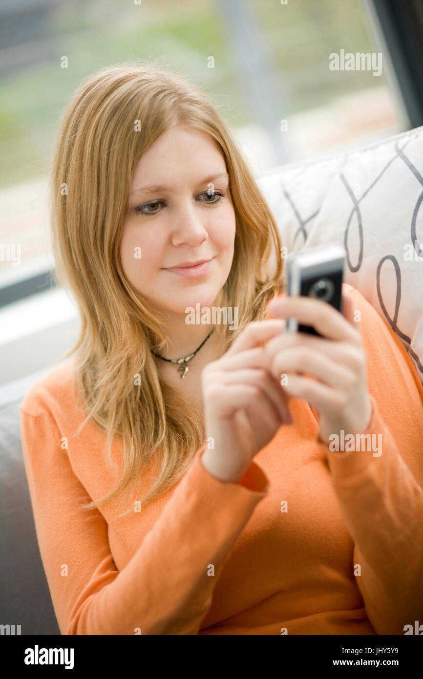 Young woman writes SMS, Junge Frau schreibt SMS Stock Photo