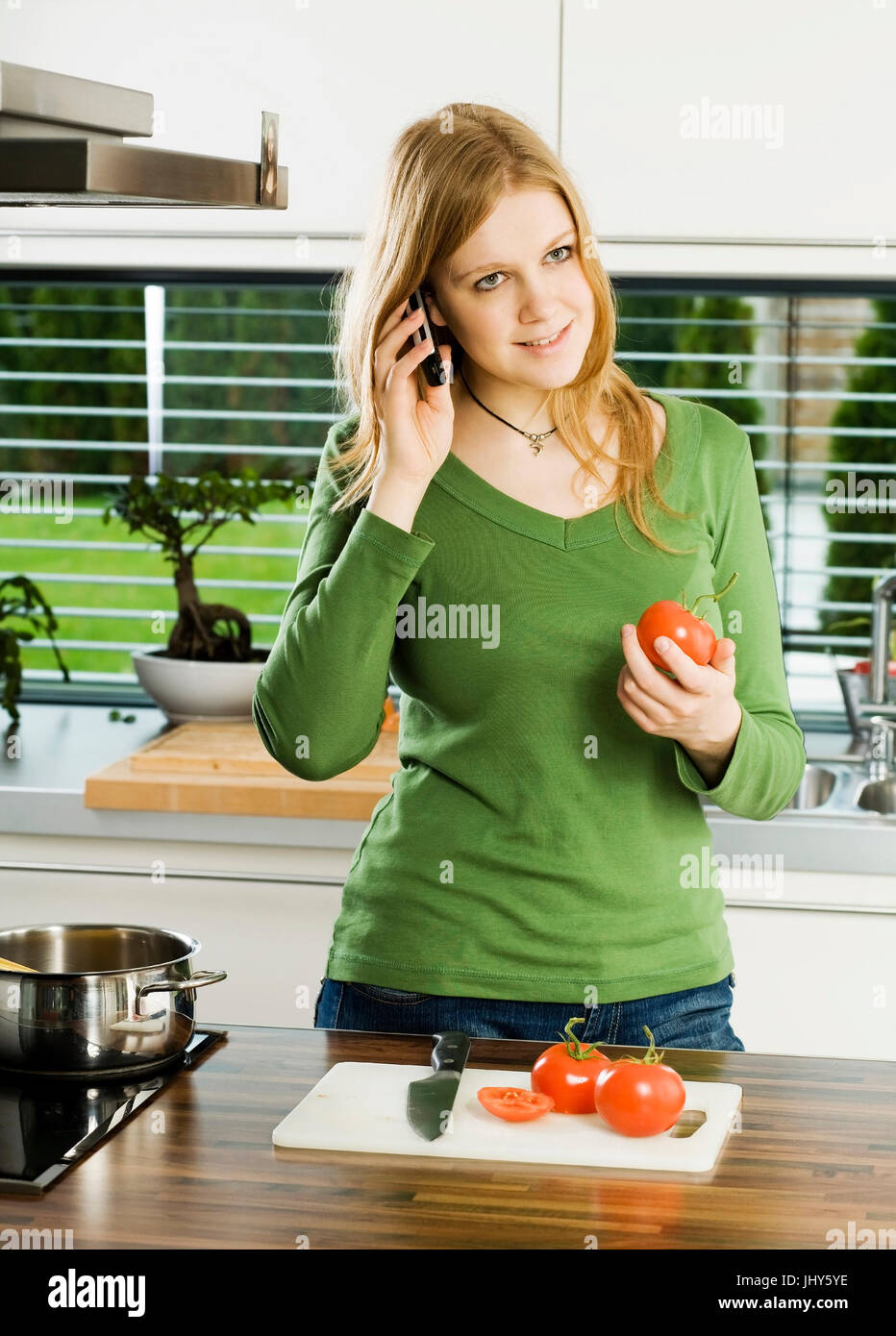 Young woman in the kitchen , Junge Frau in der Kueche Stock Photo