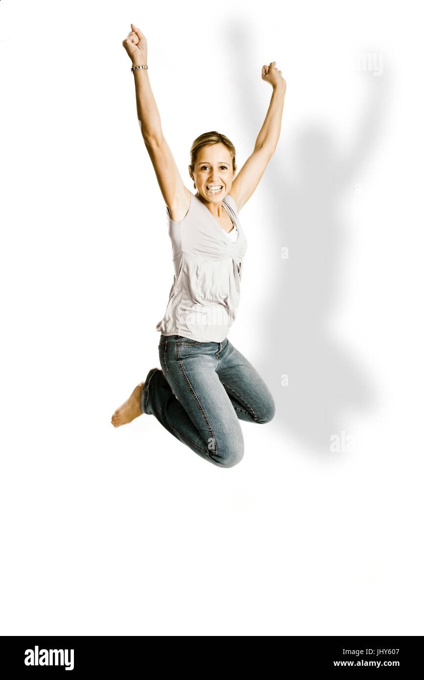Young woman makes a jump in the air, Junge Frau macht einen Sprung in die Luft Stock Photo