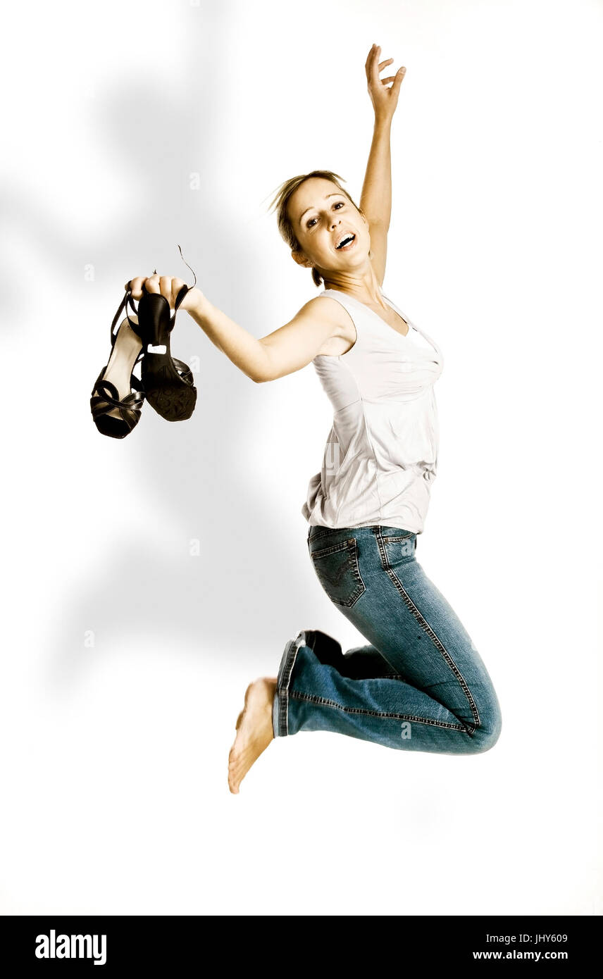 Young woman makes a jump in the air, Junge Frau macht einen Sprung in die Luft Stock Photo