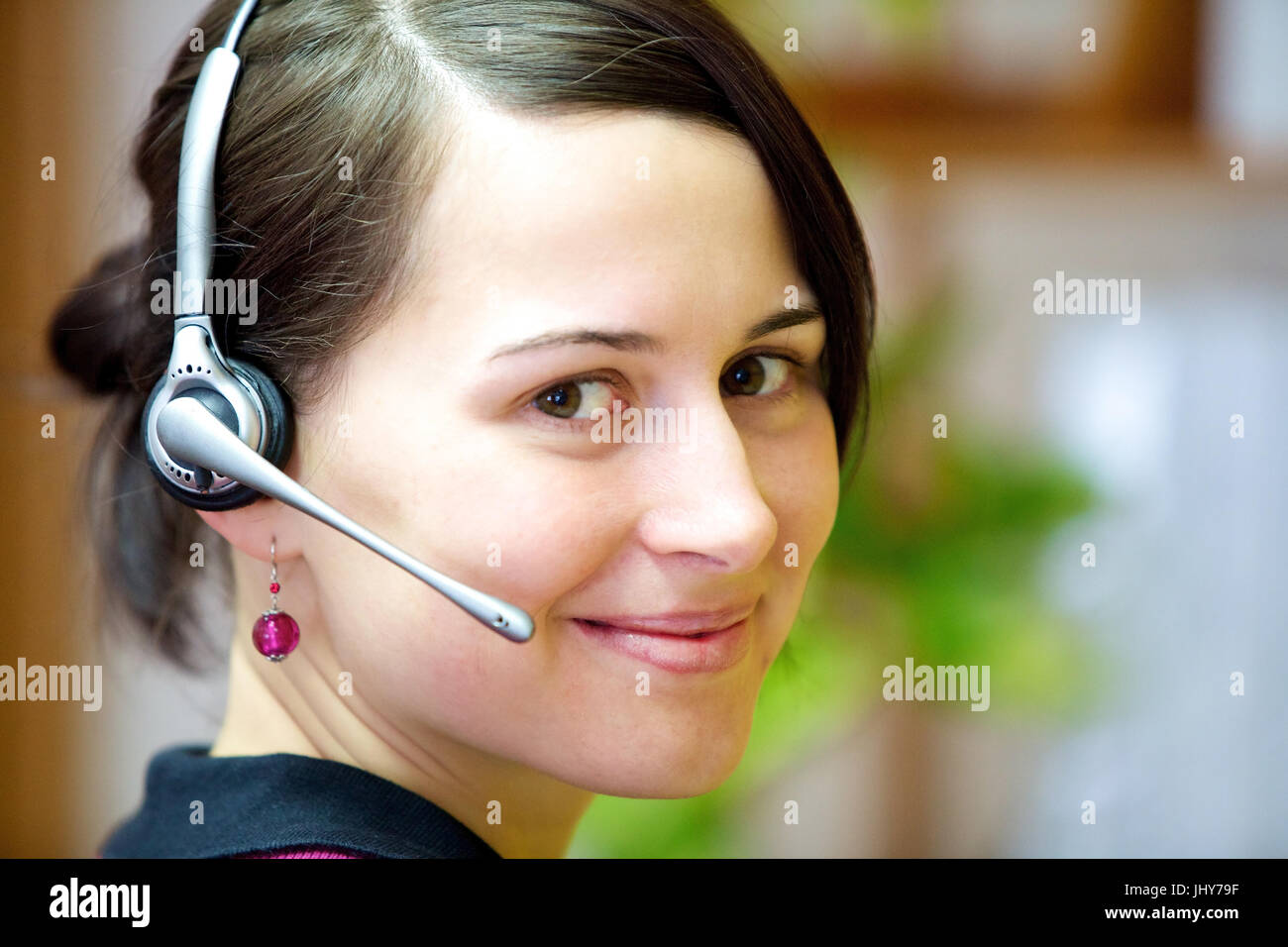 Young woman with Headset in the office - Young woman with headset, Junge Frau mit Headset im Büro - Young woman with headset Stock Photo