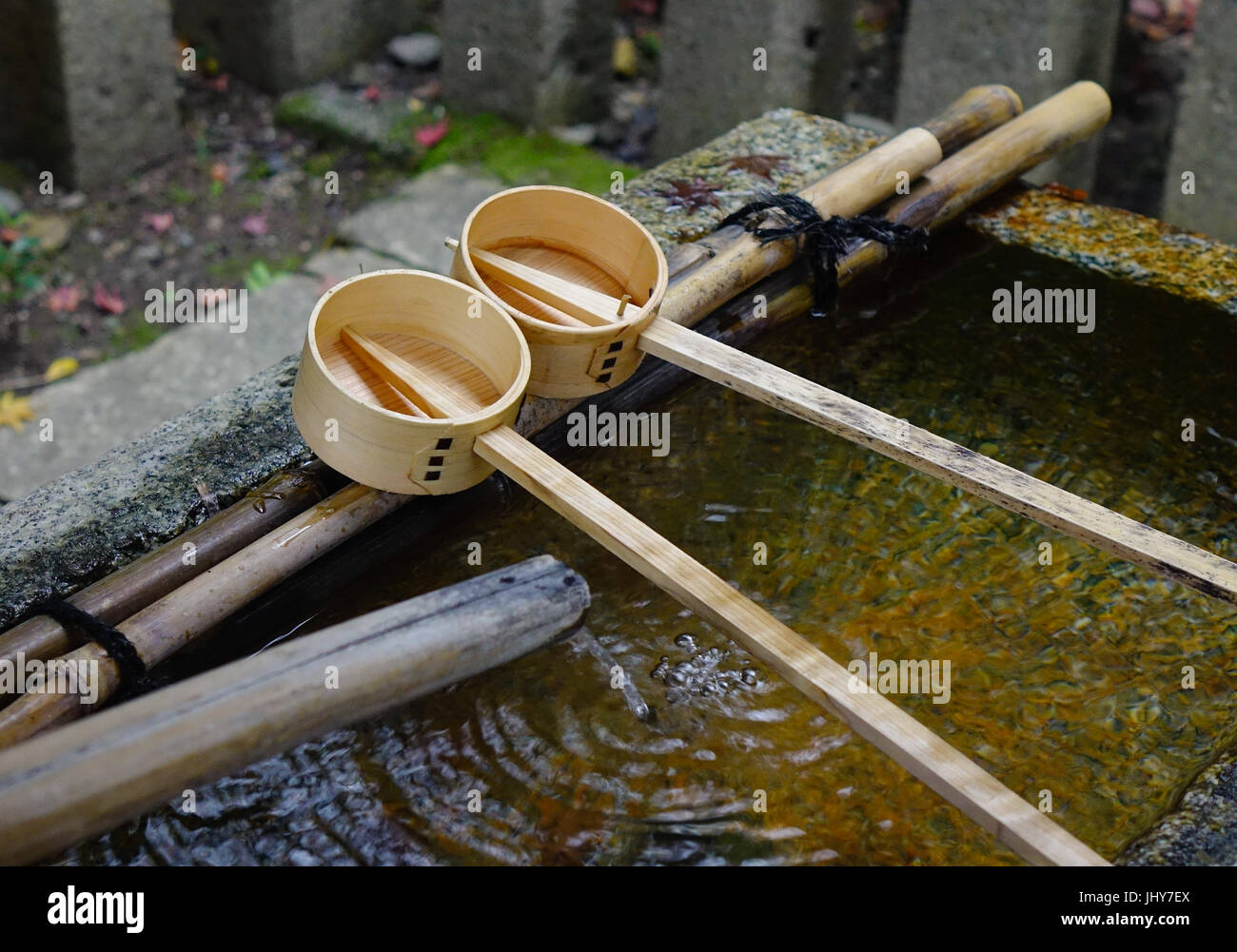 Japanese wooden ladles at Shinto temple in Kyoto, Japan. In Japan, a tsukubai is a washbasin