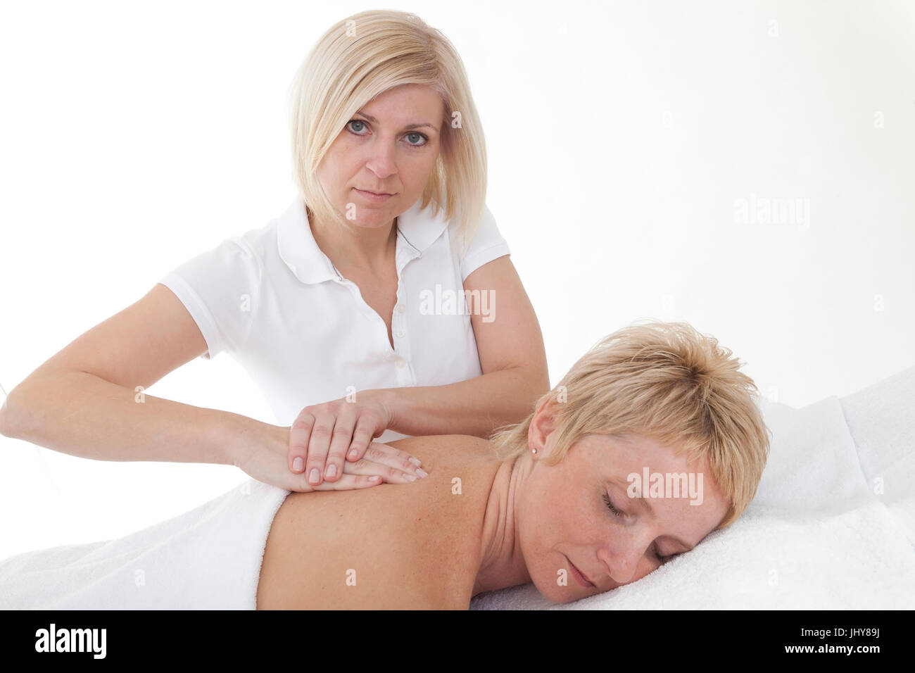 Woman receives a back massage - Woman receives a bake massage, Frau erhält eine Rückenmassage - Woman receives a back massage Stock Photo