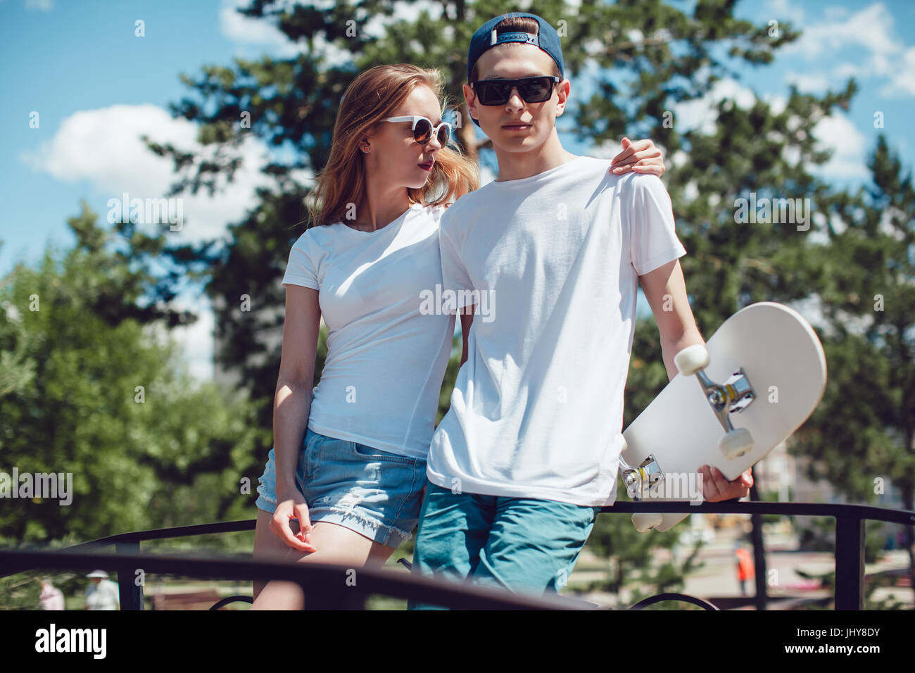 Young skater boy and girl with skateboard in white T-shirts on the Stock  Photo - Alamy