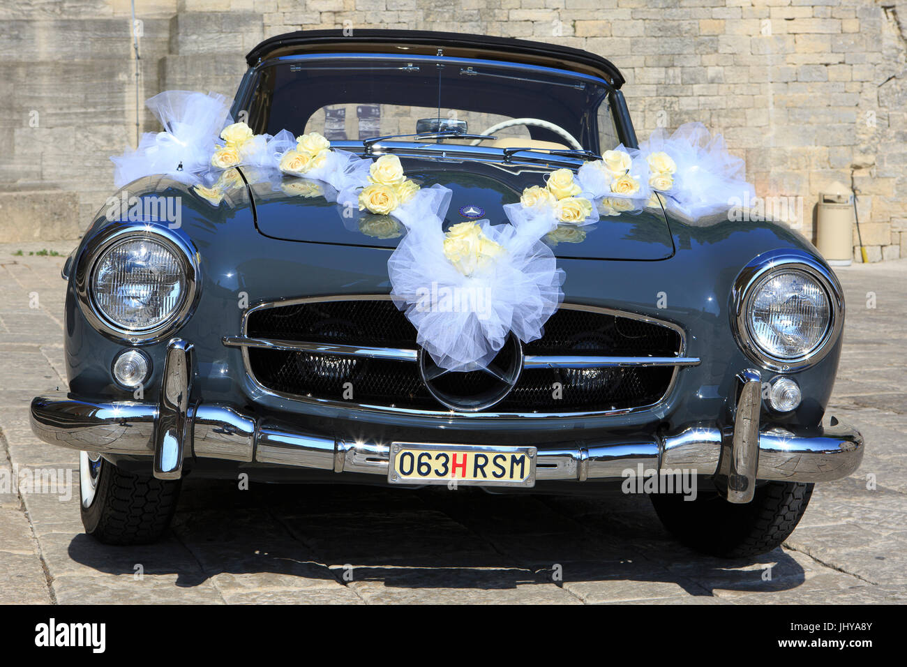 A Mercedes-Benz Gullwing 300SL with San Marino license plate used for a wedding outside the Basilica of San Marino Stock Photo