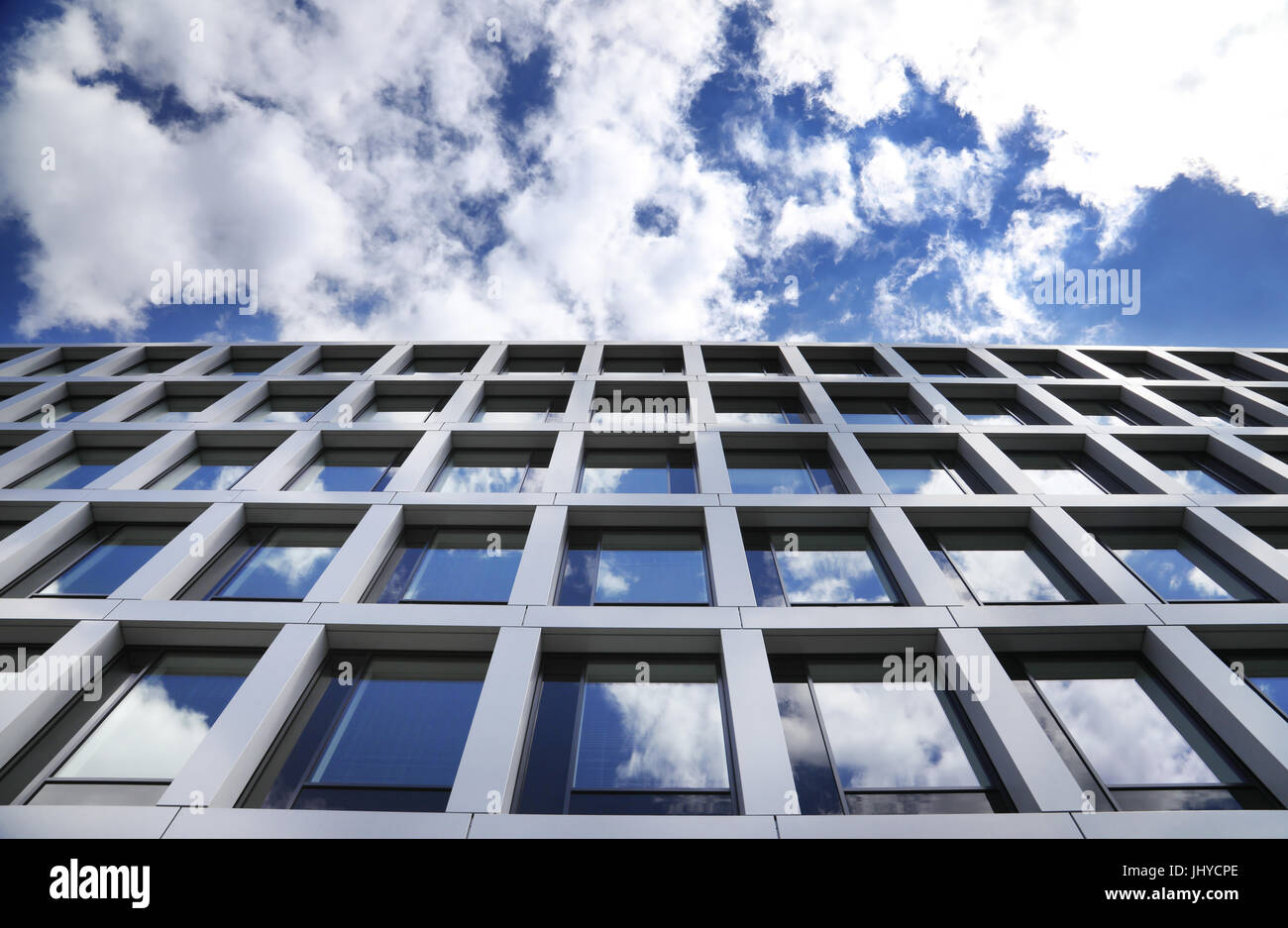 glass office building with clouds Stock Photo - Alamy