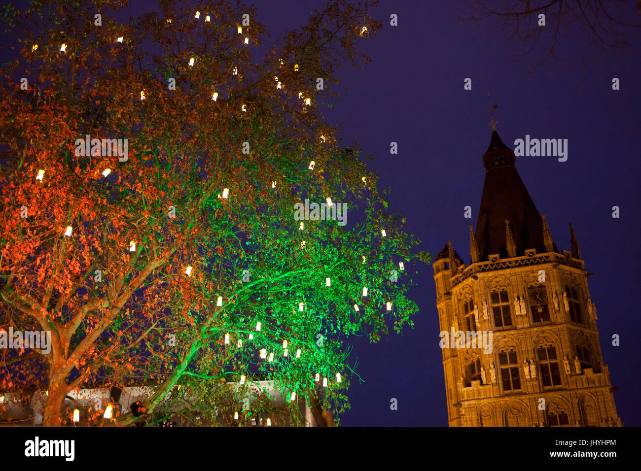Germany, Cologne, the Christmas market at the Old Market in the historic town, with lanterns decorated tree, tower of the historic town hall. Stock Photo