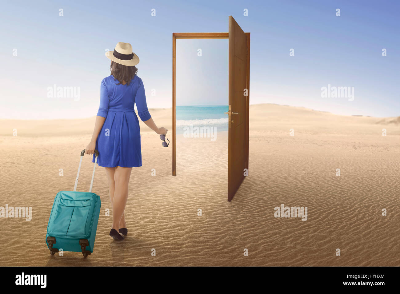 Tourist asian woman going to beach on the open door at desert Stock Photo