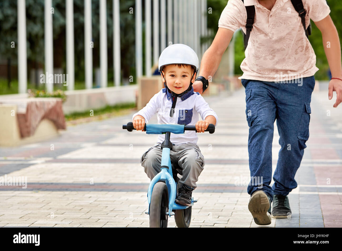 First lessons bicycle riding. Father teach his son to ride a bike Stock