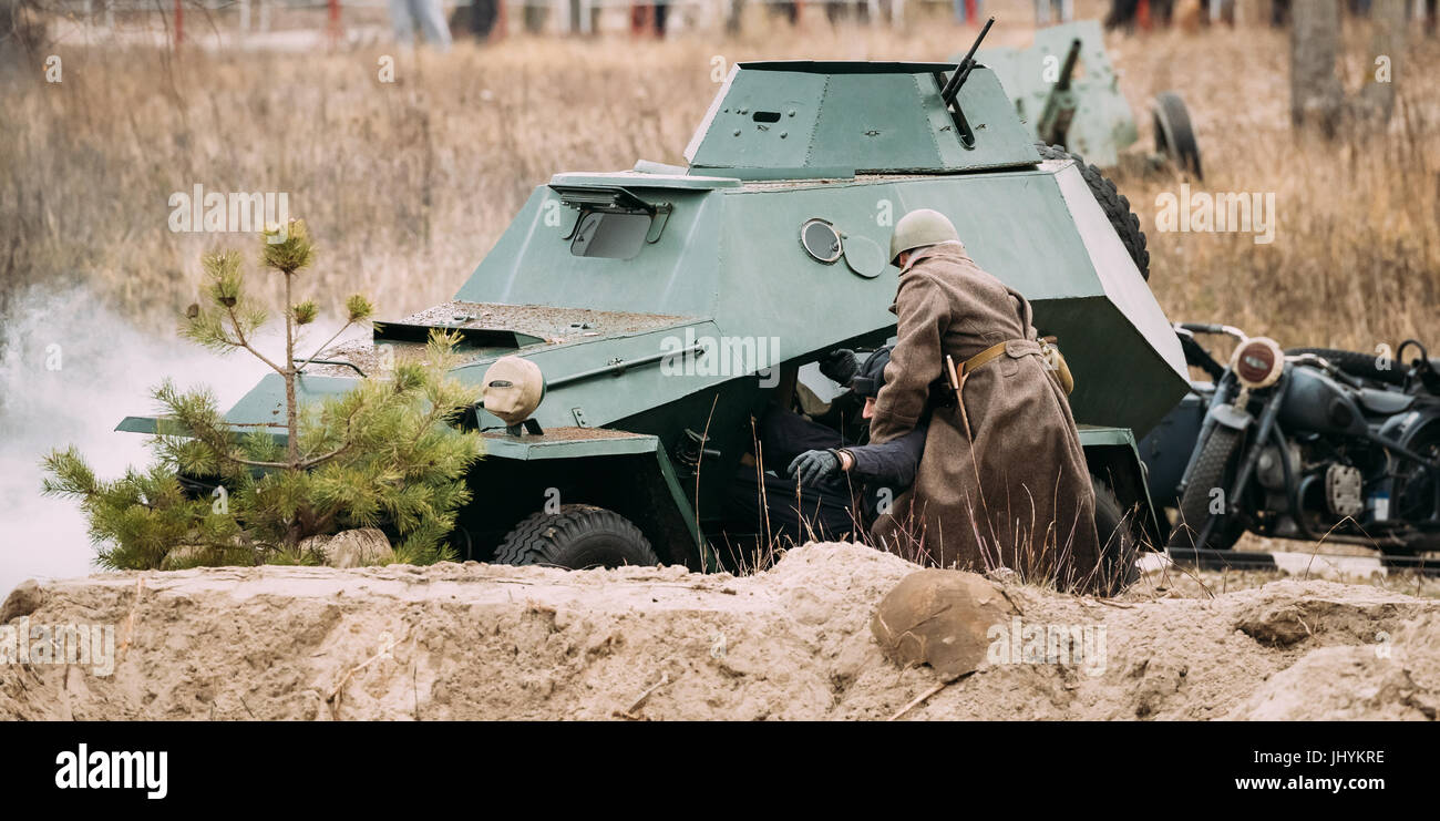 Gomel, Belarus - November 26, 2016: Re-enactor Dressed As Red Army Russian Soviet Infantry Soldier Of World War II Rescues Driver Crew From A Destroye Stock Photo