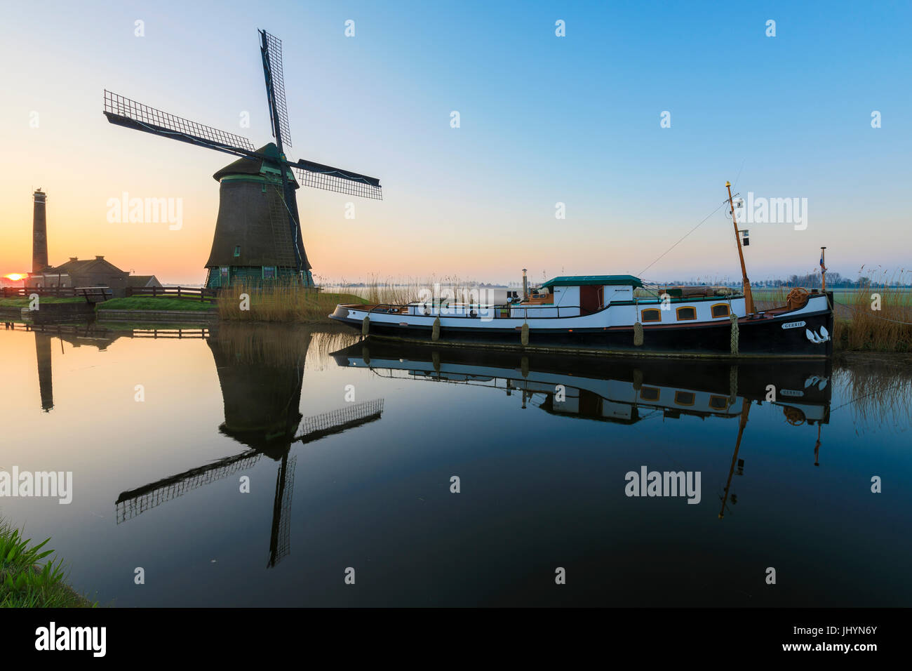 Typical windmill reflected in the canal at dawn, Berkmeer, municipality of Koggenland, North Holland, The Netherlands, Europe Stock Photo
