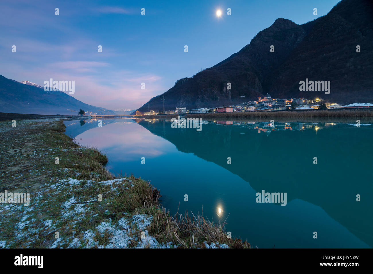 Last light of sunset on Adda River and the village of Sirta Forcola, province of Sondrio, Valtellina, Lombardy, Italy, Europe Stock Photo