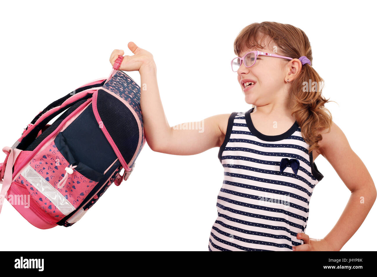 little girl trying to lift heavy schoolbag Stock Photo
