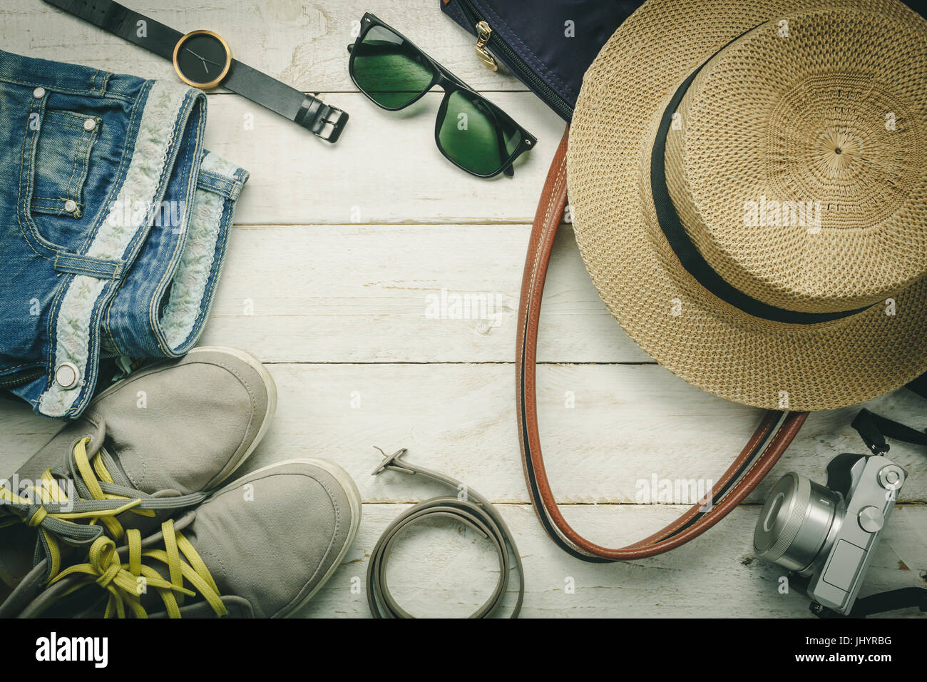 Top view accessoires to travel with women clothing  concept.belt,bag,hat,camera,necklace,trousers,watch and sunglasses on white  wood table background.f Stock Photo - Alamy