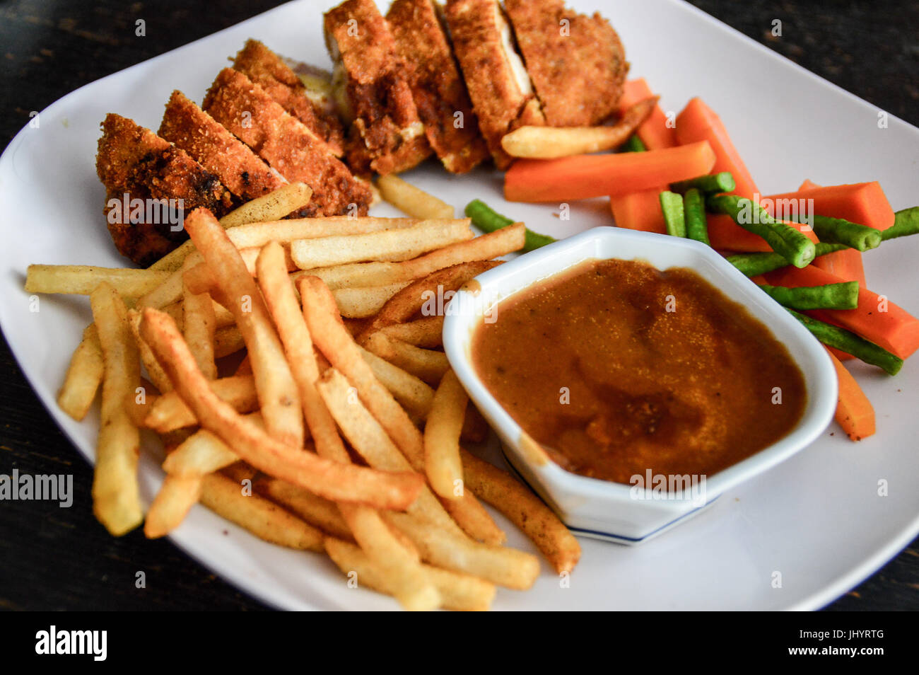 home cooked meal of chicken cordon bleu and french fries Stock Photo