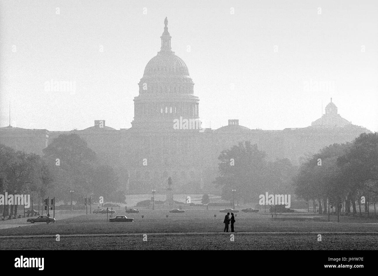Washington DC, USA. The Capitol Building looking along the National Mall in early Autumn. October 1977 The United States Capitol, often called the Capitol Building, is the home of the United States Congress, and the seat of the legislative branch of the U.S. federal government. It sits atop Capitol Hill at the eastern end of the National Mall in Washington, D.C. Though not at the geographic center of the Federal District, the Capitol forms the origin point for the District's street-numbering system and the District's four quadrants. The original building was completed in 1800 and was subsequen Stock Photo