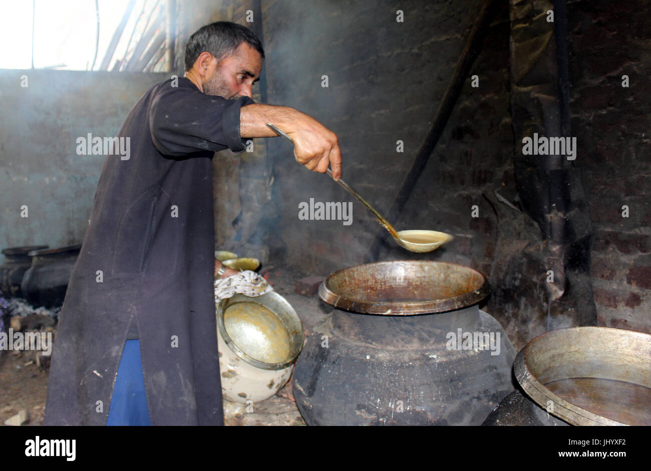 A Waze (chef) is busy cooking Wazwan ( a multi course meal) for the