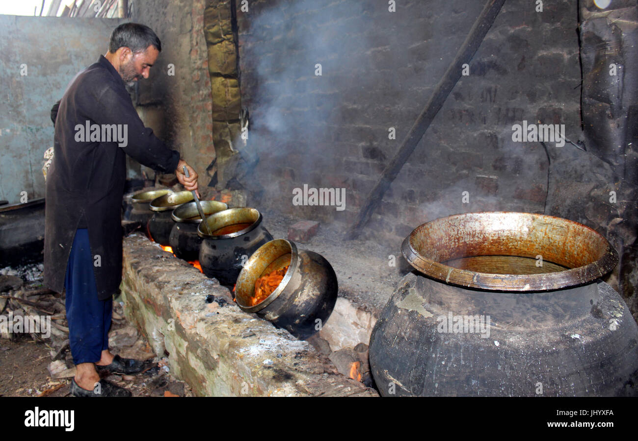 A Waze (chef) is busy cooking Wazwan ( a multi course meal) for the