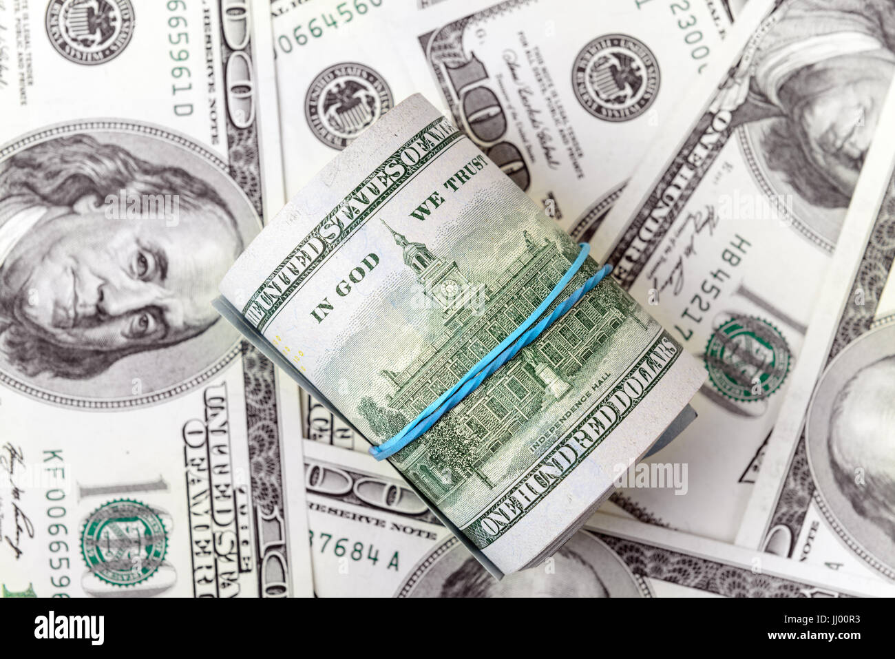 Roll of dollars on a background of American dollar bills Stock Photo