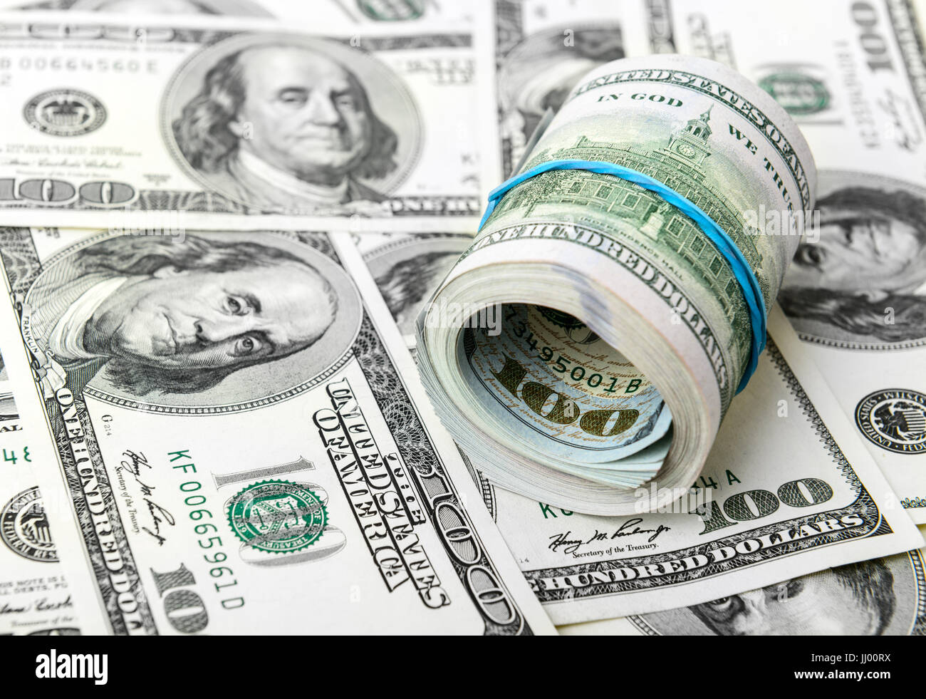 Roll of dollars on a background of American dollar bills Stock Photo